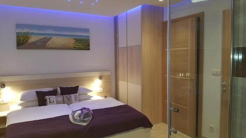 a bedroom with a bed and a glass shower at Luxury Villa Star Lights Trogir - heated pool, hot tub, gym, billiard in Trogir