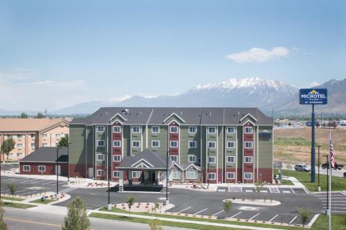 a rendering of a hotel with mountains in the background at Microtel Inn & Suites by Wyndham Springville in Springville