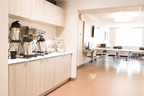 a kitchen and dining room with a table and chairs at Microtel Inn & Suites by Wyndham Springville in Springville