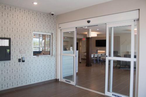 a room with sliding glass doors and a living room at Microtel Inn & Suites by Wyndham Springville in Springville