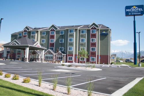 a hotel with a parking lot in front of it at Microtel Inn & Suites by Wyndham Springville in Springville