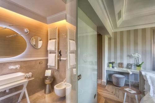 a bathroom with a shower and a sink and a toilet at Hotel Palazzo Manfredi – Small Luxury Hotels of the World in Rome