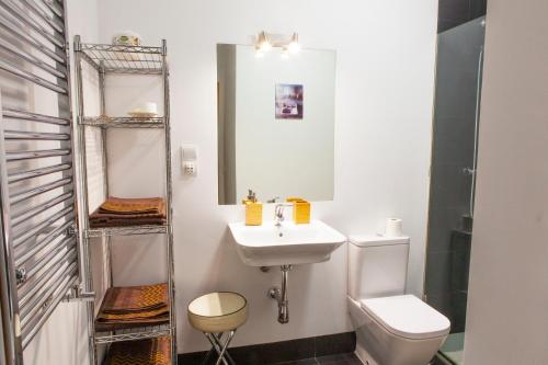 a white bathroom with a sink and a toilet at Segovia in Madrid