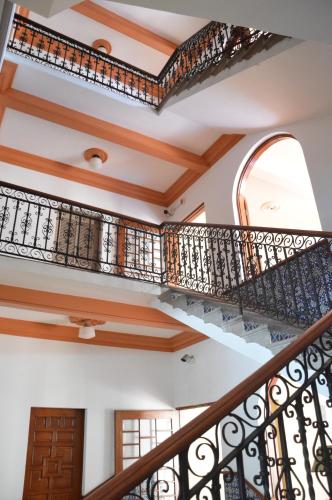 a staircase in a house with wood and iron railings at Hotel Los Monteros in Ciudad Victoria