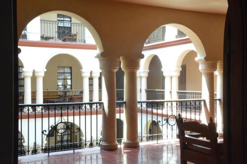 a view of the lobby of a building with columns at Hotel Los Monteros in Ciudad Victoria