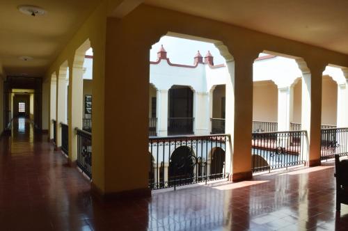 an empty hallway of a building with a fence at Hotel Los Monteros in Ciudad Victoria