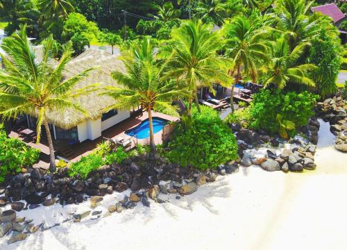 an aerial view of a resort on a beach with palm trees at Sea Change Villas in Rarotonga