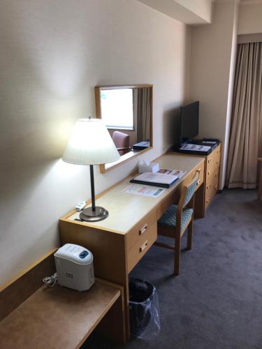 an office with a desk with a lamp and a computer at Hotel Grand Terrace Chitose in Chitose