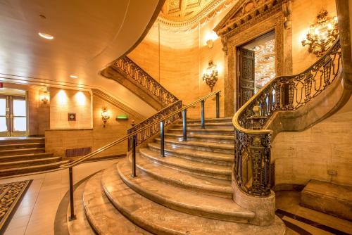 a spiral staircase in a building with a stair case at Hotel Du Pont in Wilmington