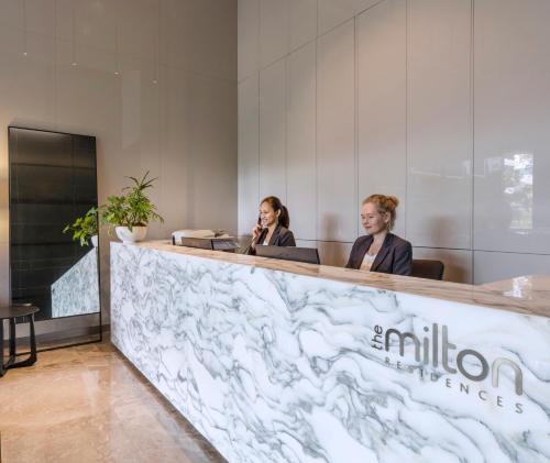 two women sitting at a counter in a lobby at The Milton Brisbane in Brisbane