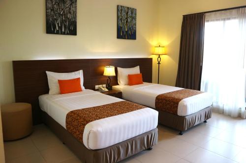 Ένα ή περισσότερα κρεβάτια σε δωμάτιο στο Golden Tulip Essential Belitung
