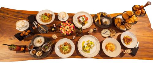a table full of plates of food on a table at The Edge Bali in Uluwatu