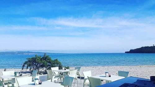 a group of tables and chairs on a beach at B&B Quintino Sella in Iglesias