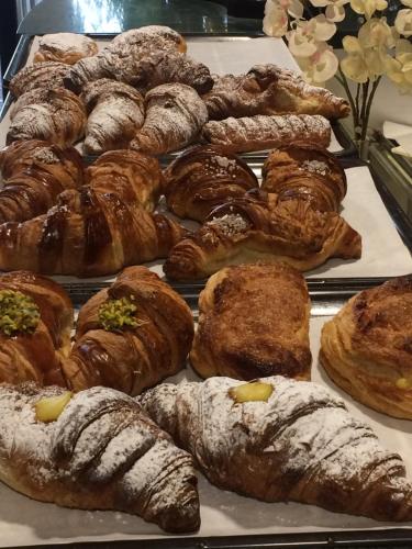 a bunch of croissants and other pastries on a tray at Cala Arenella in Sciacca