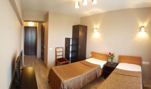 a hotel room with two beds and a table at Hotel Turist in Chişinău