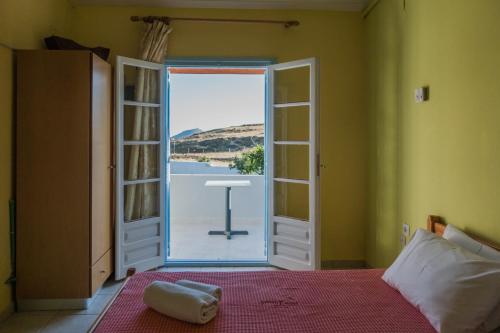 a bedroom with a bed and an open door at Gregory's Village in Platy