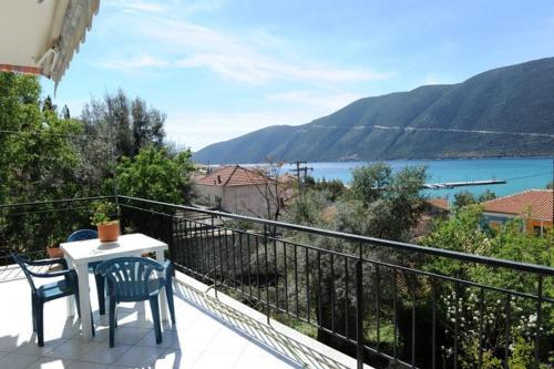 a balcony with a table and chairs and a view of the water at Mediterraneo studios in Vasiliki