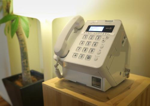 a phone sitting on a table next to a lamp at Akihabara Washington Hotel in Tokyo
