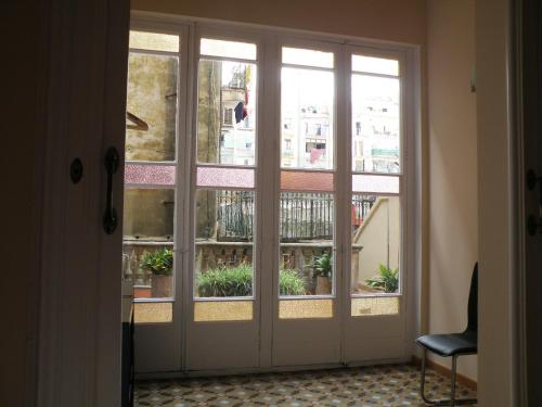 a sliding glass door with a view of a balcony at Center Gran Via in Barcelona