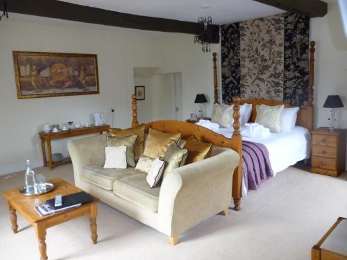 a bedroom with a bed and a couch at Charles Cotton Hotel in Hartington