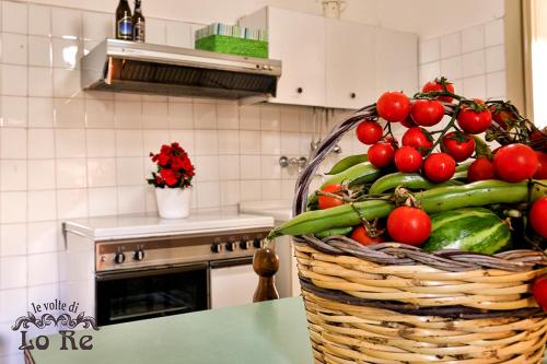 a basket of vegetables on a table in a kitchen at Le Volte di Lo Re in Surbo