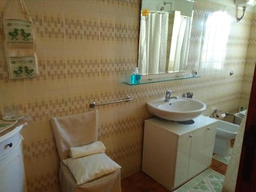 a bathroom with a sink and a mirror at Daddos in Flumini di Quartu