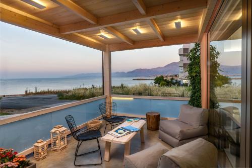 a screened in porch with a view of the ocean at Idolio Suite in Hersonissos