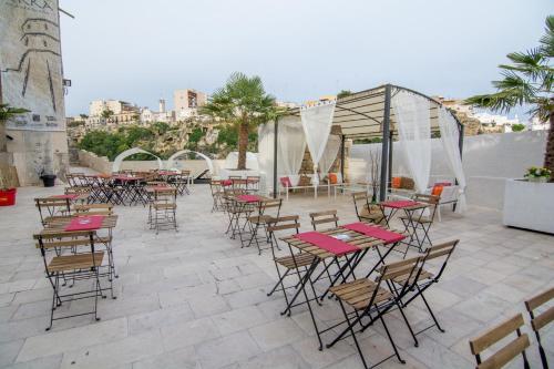 a group of tables and chairs on a patio at Rifugio Massafera 2 in Massafra