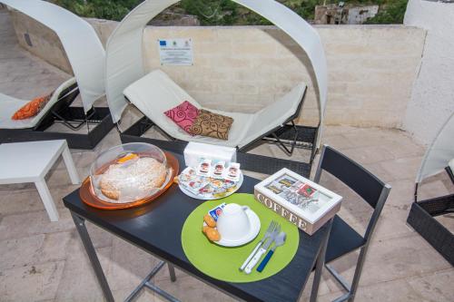 a table with a plate of food on it at Rifugio Massafera 2 in Massafra