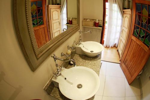 a bathroom with a sink and a mirror at Oleander Guest House in Kimberley