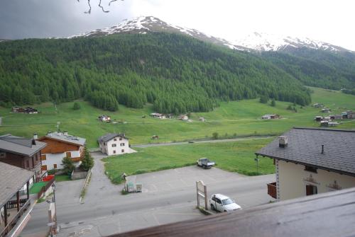 a view of a town with a mountain in the background at Hotel Astoria in Livigno