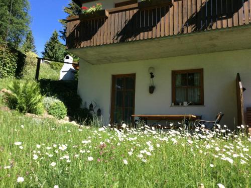 a house with a field of flowers in front of it at Ferienhaus Sükar in Bad Kleinkirchheim