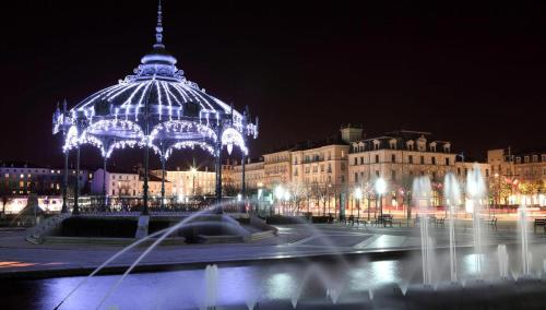 a large building with a lit up dome at night at Campanile Valence Sud in Valence