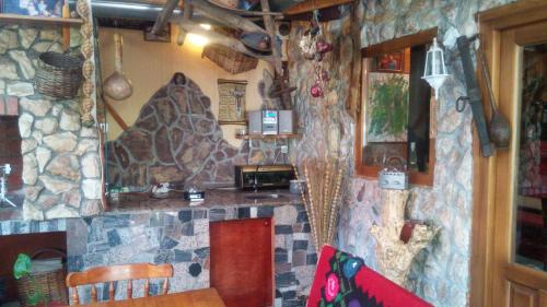 a bar in a restaurant with a stone wall at S&Z Hostel in Banja Luka