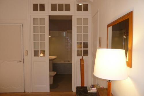 baño con aseo, lámpara y ventana en Une Chambre Dans L'atelier De R en Rouen
