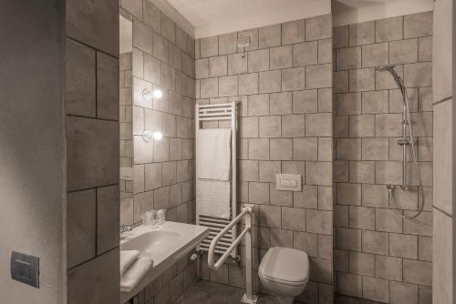 a bathroom with a toilet and a sink and a shower at Hotel San Daniele in San Daniele del Friuli
