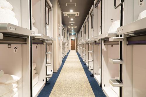 a long aisle in a subway train at Mt.Fuji Cabin & Lounge Highland Station Inn (Capsule Hotel) in Fujikawaguchiko