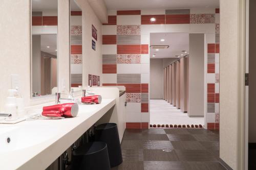 a bathroom with two sinks and a red phone at Mt.Fuji Cabin & Lounge Highland Station Inn (Capsule Hotel) in Fujikawaguchiko