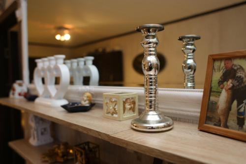 a counter top with a mirror and some glass bottles at Cottage Viardo in Vehkataipale