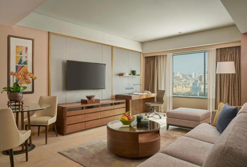 a living room with a couch and a tv at Shangri-La Changchun in Changchun