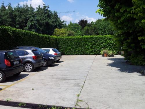 a row of cars parked in a parking lot at Hotel Post in Bergamo