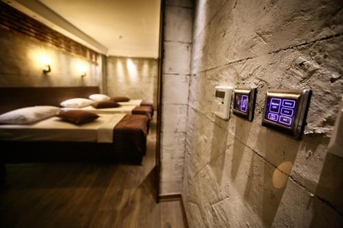 a row of beds in a room with a wall at Elibol Hotel Old City in Istanbul
