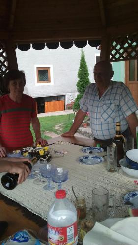 two people sitting at a table with a toy car on it at Pensiunea Tarina in Şuncuiuş