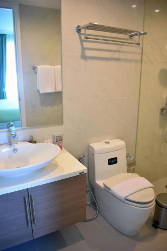 a bathroom with a white toilet and a sink at My resort Huahin by D511 in Hua Hin
