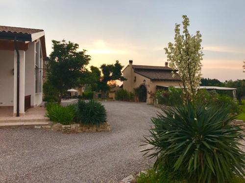 a house with a gravel driveway in front of a house at Agriturismo Sambuco in Pastrengo