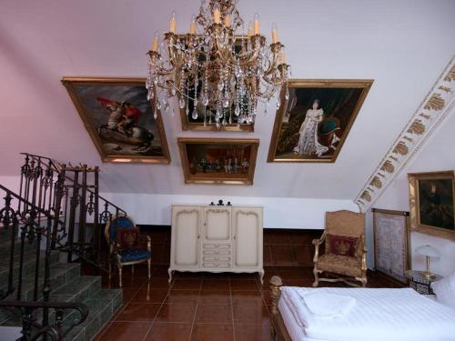 a room with a chandelier and pictures on the wall at Rittergut Haus Laer in Bochum