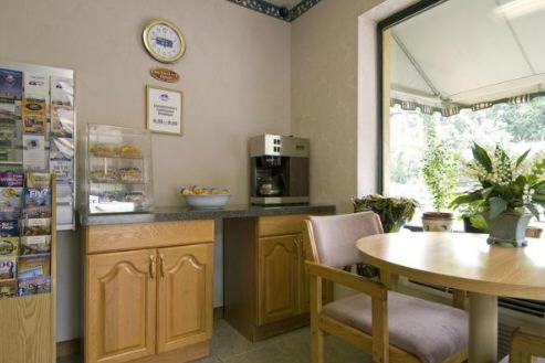 a kitchen with a table and a counter with a table and chairs at Cabarrus Inn in Concord