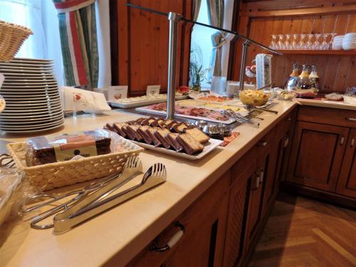 a kitchen counter with a buffet of food on it at Gasthof Kampenwand Aschau in Aschau im Chiemgau