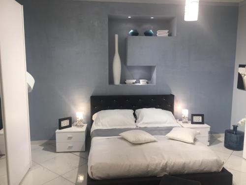 a bedroom with a large bed with two pillows at Alba Camere in Palermo