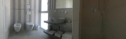 a bathroom with a toilet and a sink and a urinal at Stellamare in Caorle